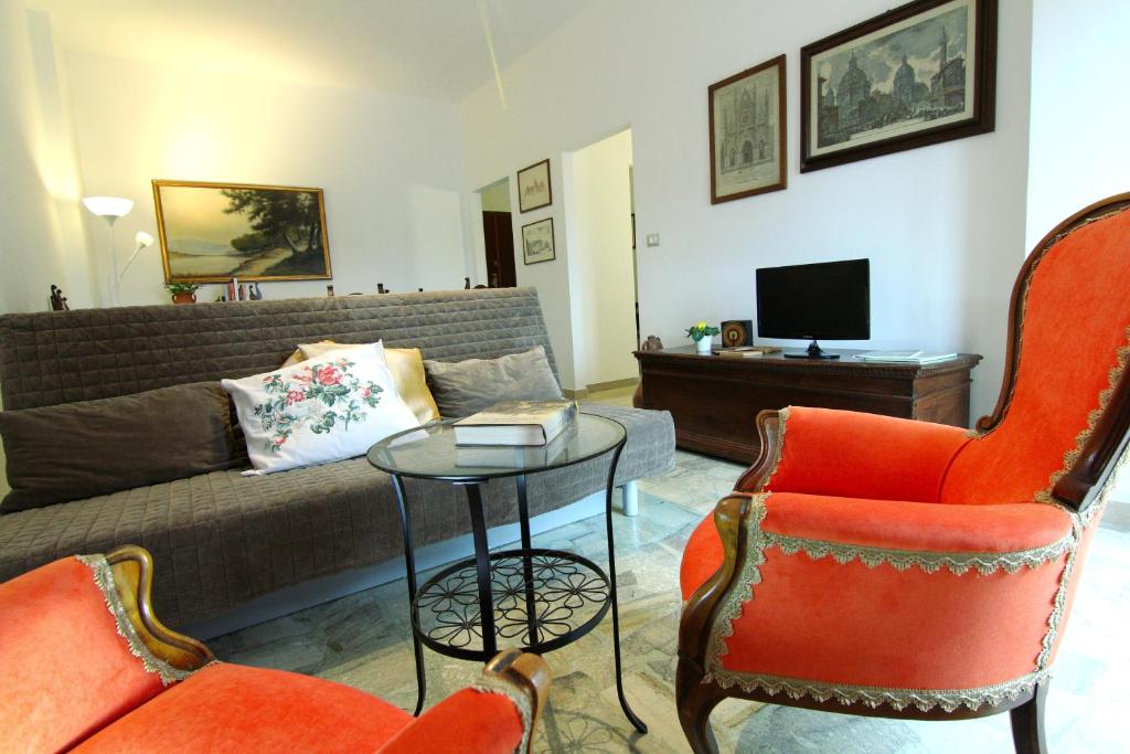 a living room with a couch and two chairs and a table at casa vovos' in Terni