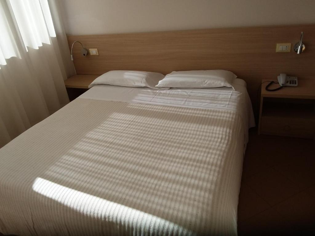 Postel nebo postele na pokoji v ubytování Albergo Nyers