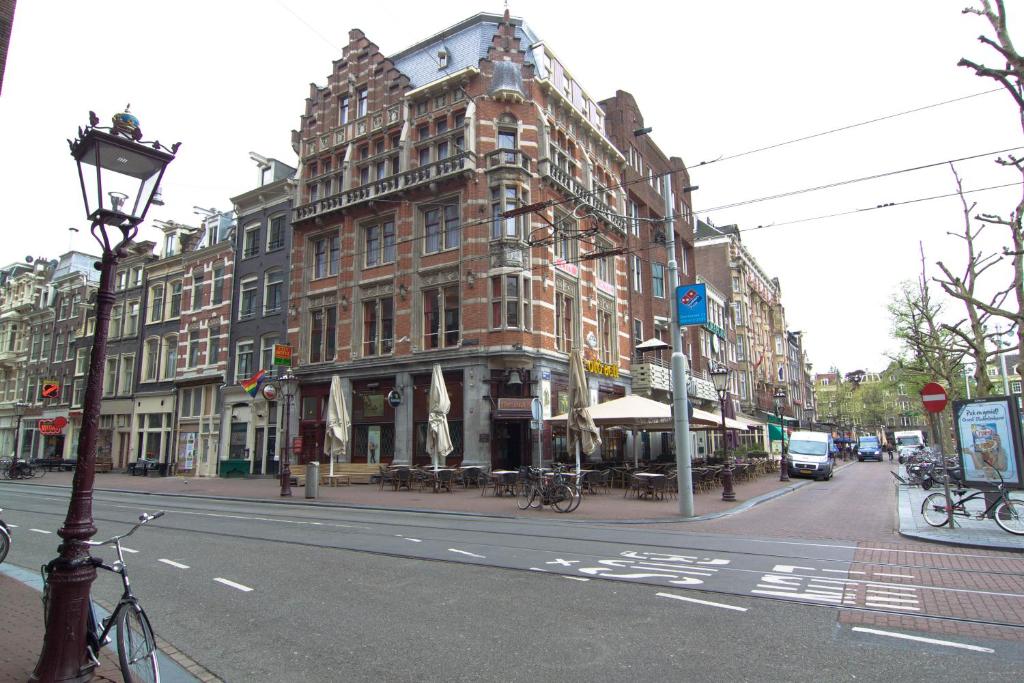 a large brick building on a city street at City Hotel in Amsterdam