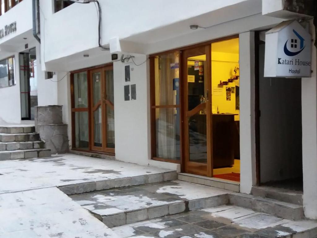 a facade of a building with glass doors at Catari's House in Machu Picchu