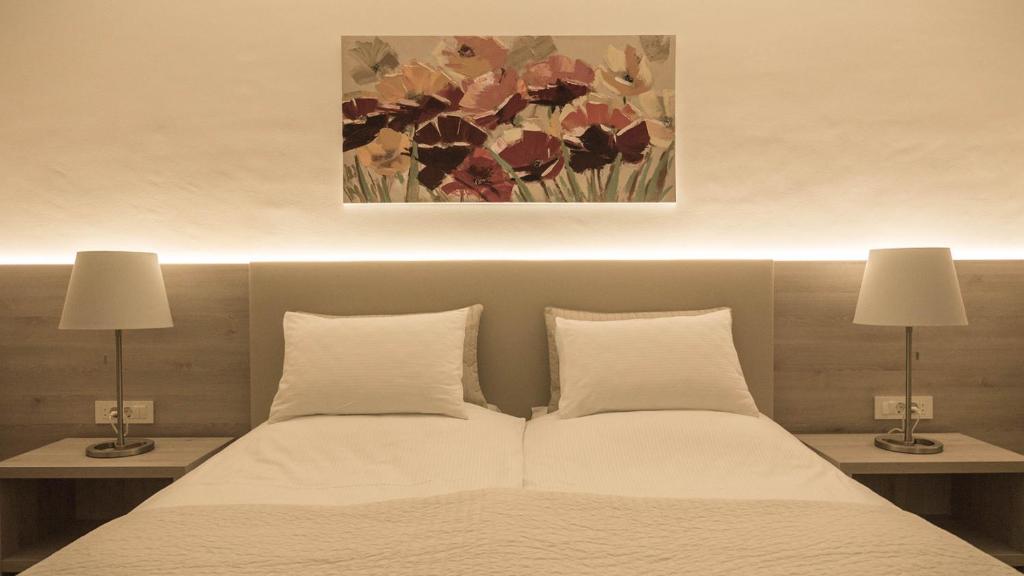 Postel nebo postele na pokoji v ubytování Hotel Magdalena