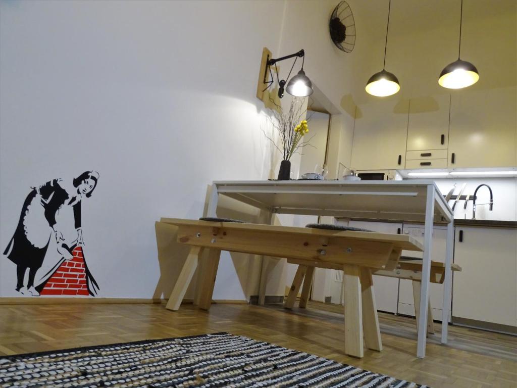 a living room with a wooden floor and a wooden table at Best Choice Urban - FREE Parking in Graz