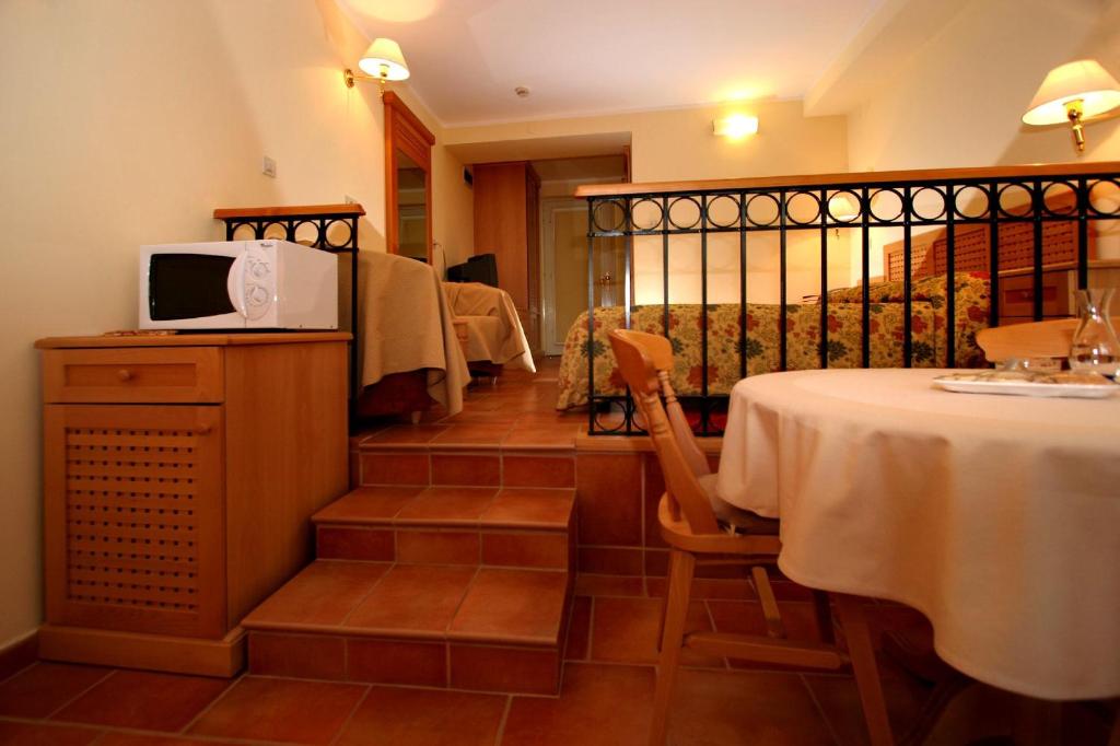 a room with a table with a microwave on a counter at Apartments Bellevue Plava Laguna in Poreč