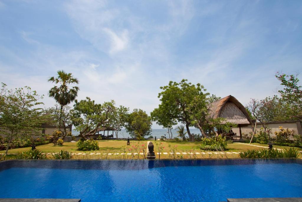 a swimming pool in front of a resort at Villa Wilali in Pemuteran