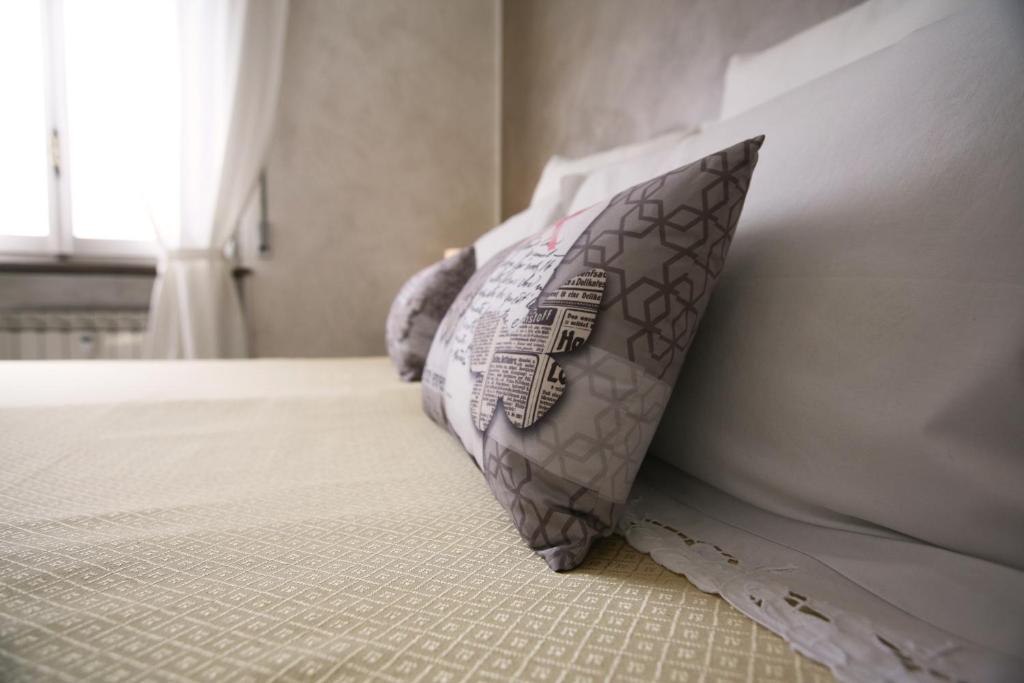 a pillow sitting on a bed in a bedroom at ELA GUEST HOUSE in Rome