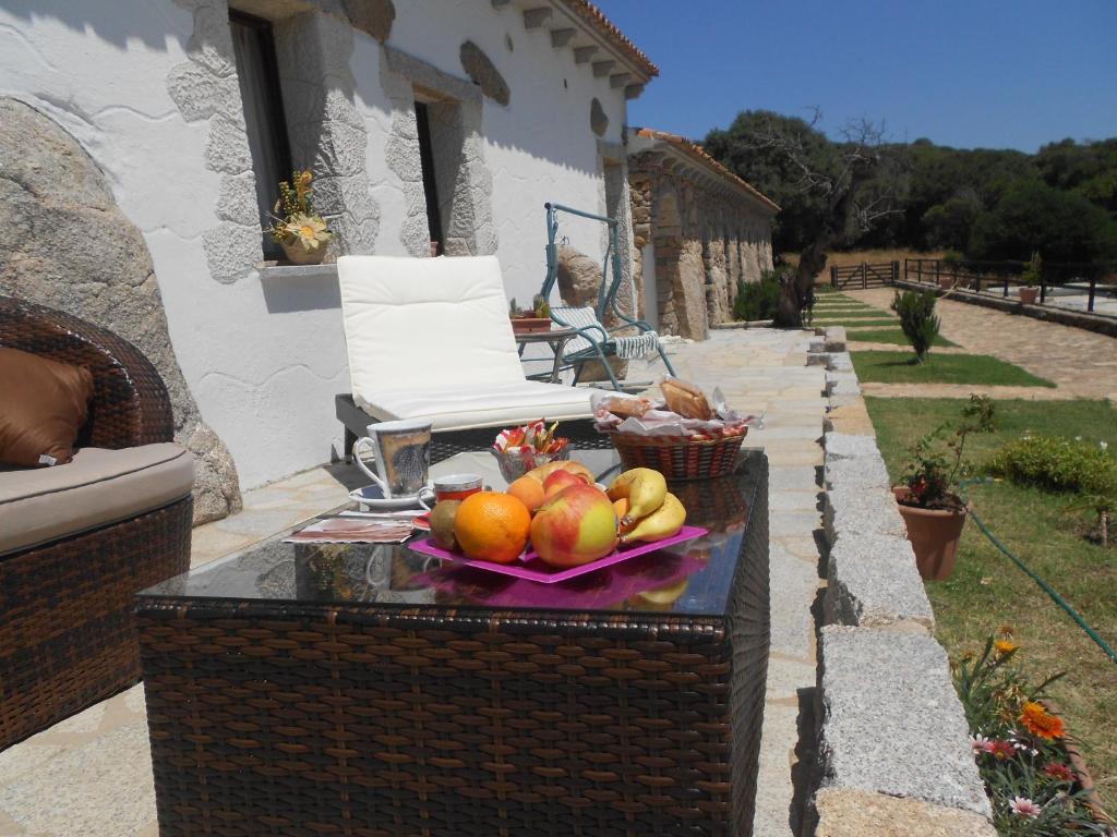 a bowl of fruit on a table on a patio at B&B L' Incantu in Santa Teresa Gallura