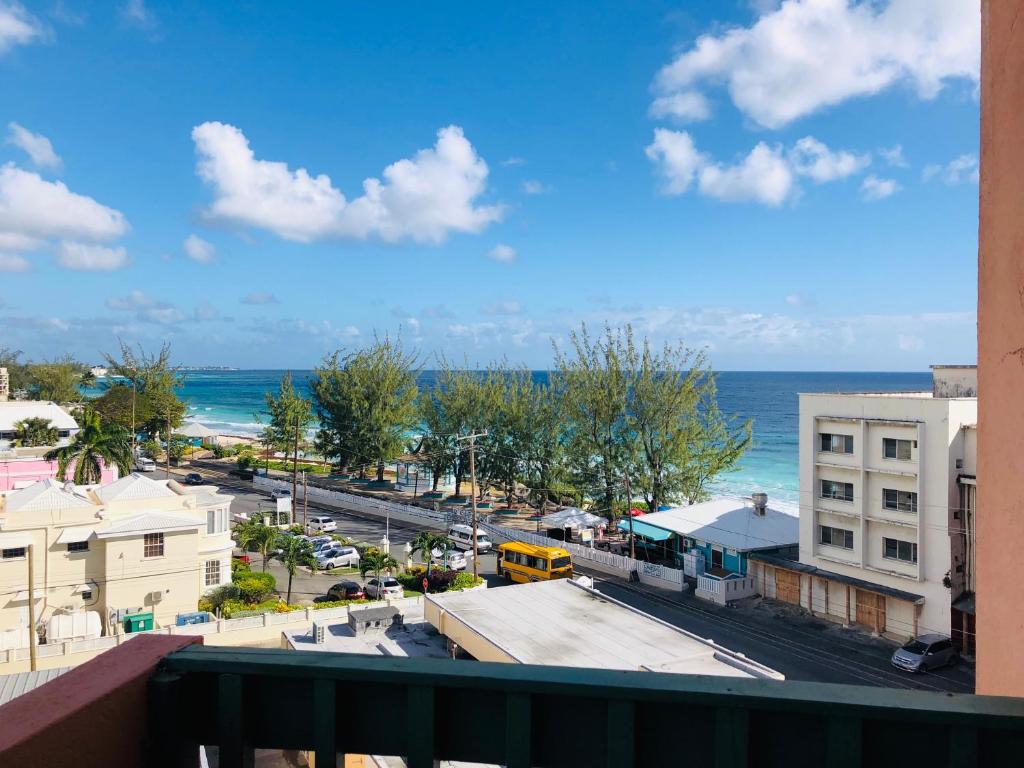 a view from a balcony of a city with the ocean at Opp Sea, Beach, Restaurants 5b - 2bed 2 bath 5B Hastings Tower in Bridgetown