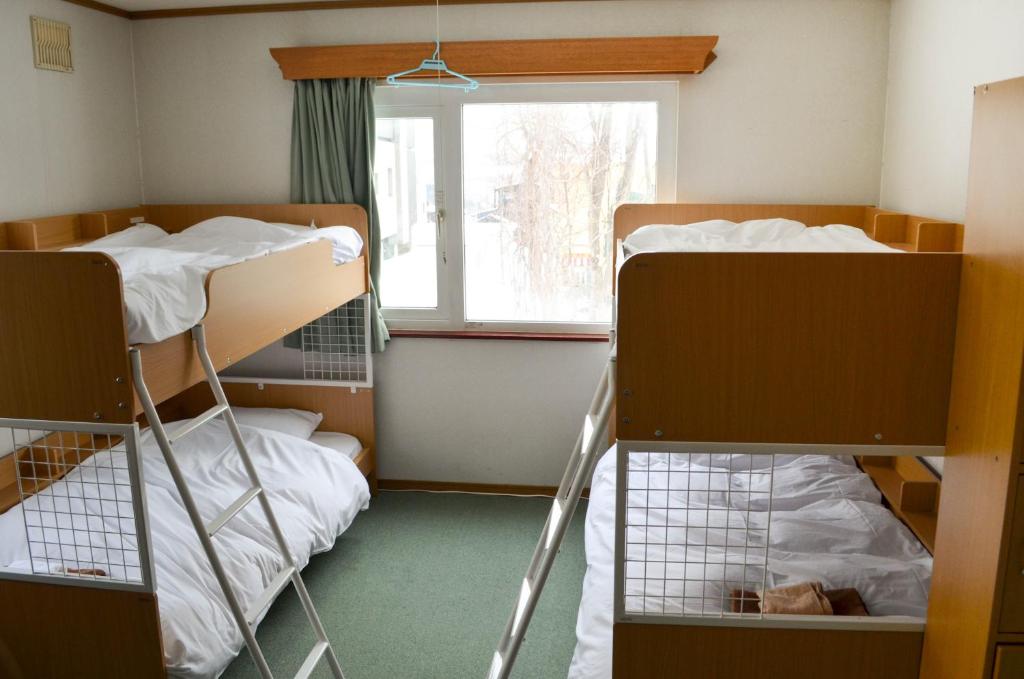 Postel nebo postele na pokoji v ubytování Absolute Niseko Lodge