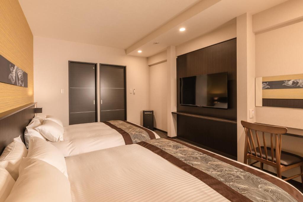 Postel nebo postele na pokoji v ubytování Zen Kyoto Apartment Hotel