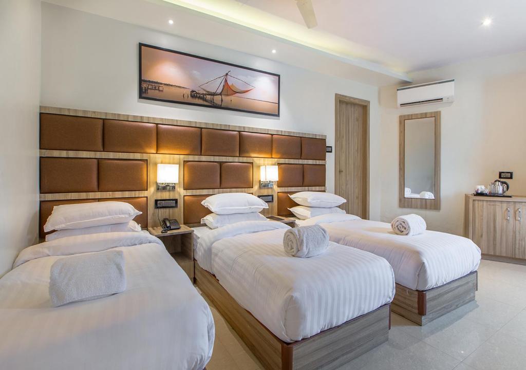 Postel nebo postele na pokoji v ubytování Aura One Hotel
