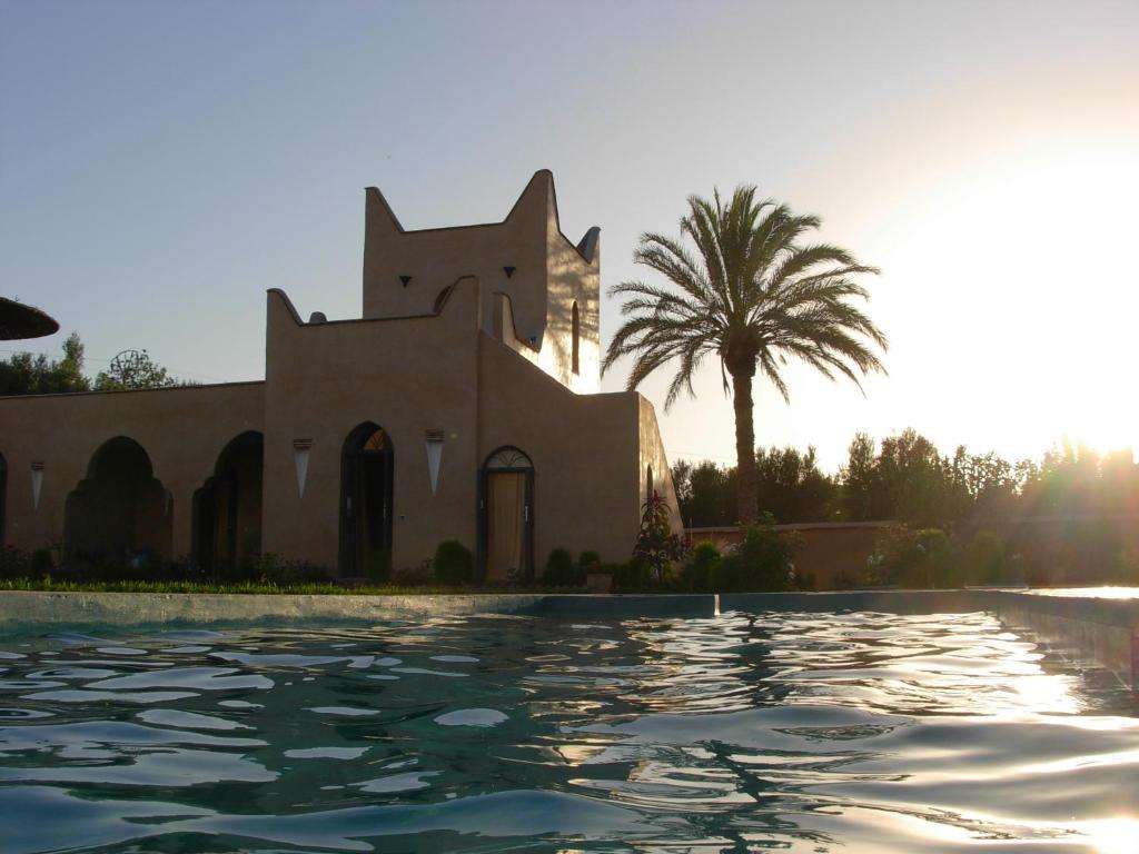 une villa avec une piscine en face d'un bâtiment dans l'établissement Le Jardin Des Epices, à Taroudant