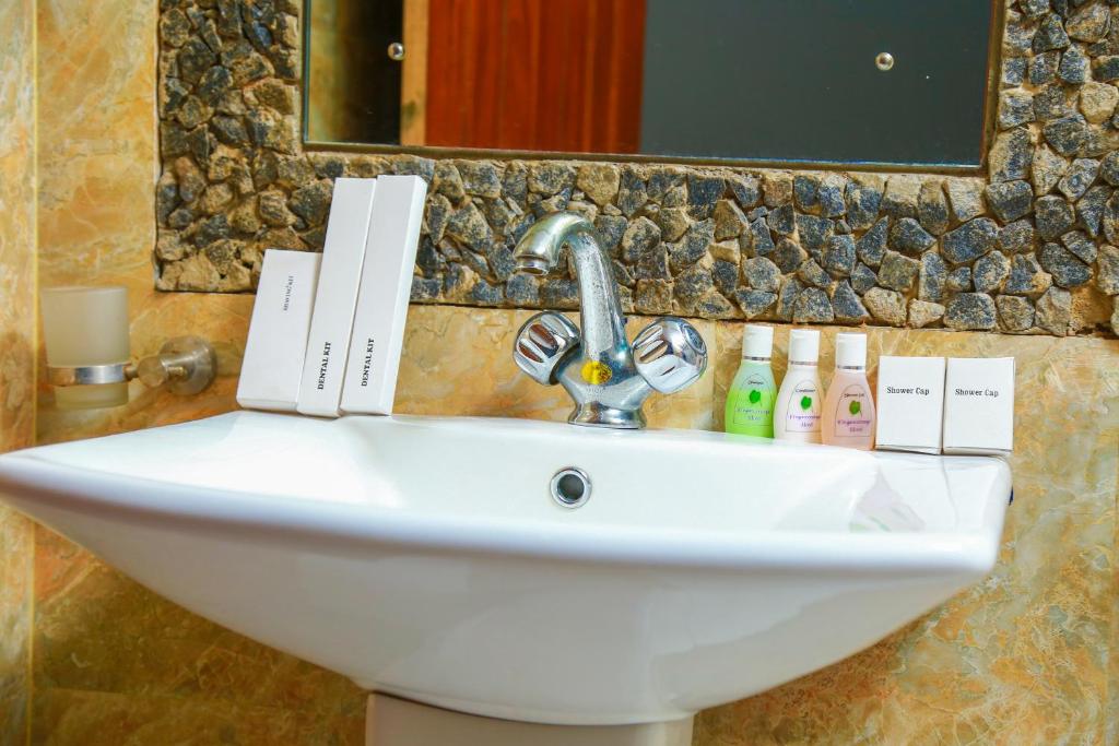 a white sink in a bathroom with a mirror at Elegance Range Resort in Kandy