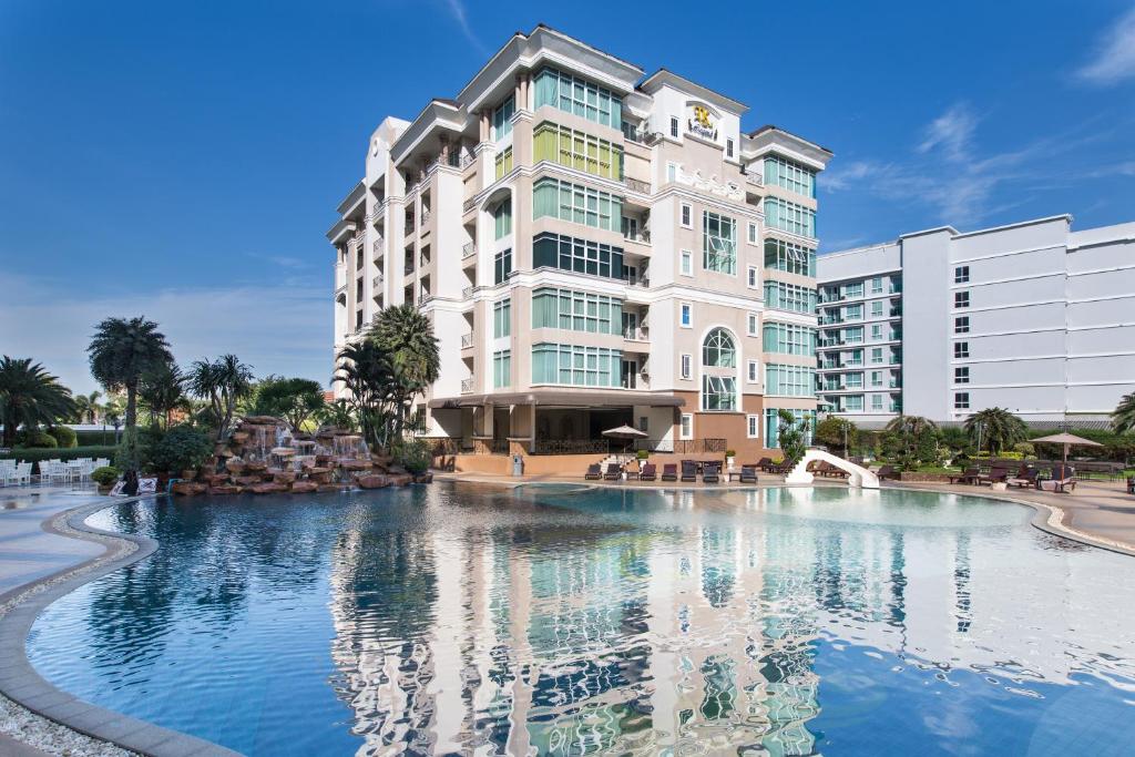 a hotel with a large pool in front of a building at Beautiful Apartment D6 Central Pattaya in Pattaya Central