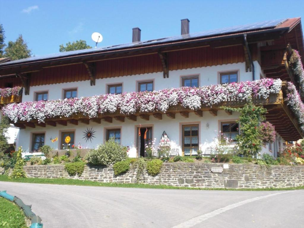 a house with flowers on the side of it at Ferienhof Altmann in Arrach
