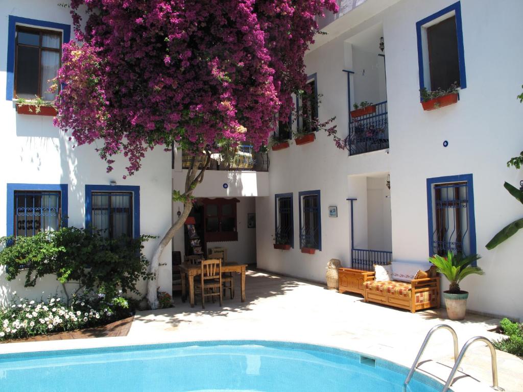 a villa with a swimming pool and flowers at Dalyando Apart in Dalyan