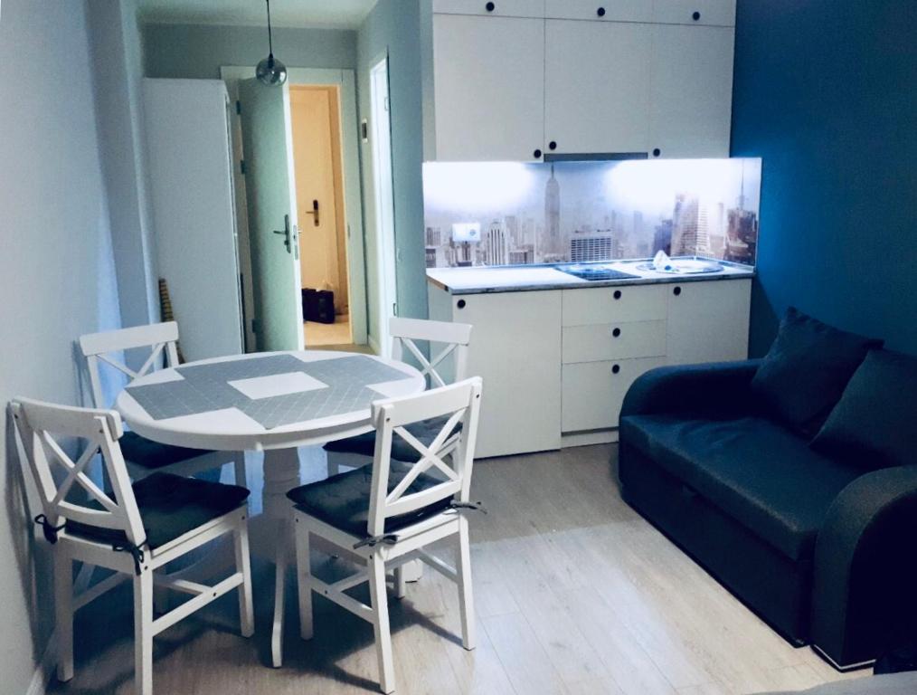 a living room with a table and chairs and a couch at New Gudauri Loft 2,apart 106 in Gudauri