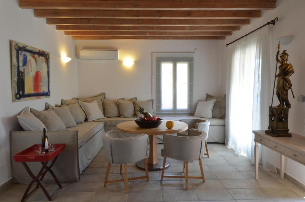 a living room with a couch and a table at Aegea Blue Cycladic Resort in Zorgos 