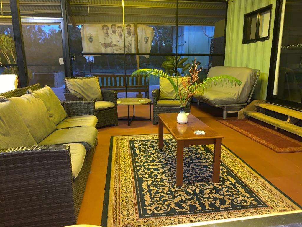 a living room with couches and a coffee table at Rustic Retreat in Dundee Beach
