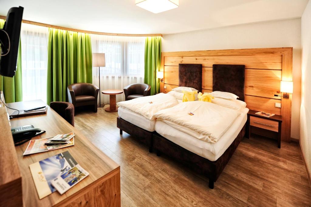 Postel nebo postele na pokoji v ubytování Hotel Arnika