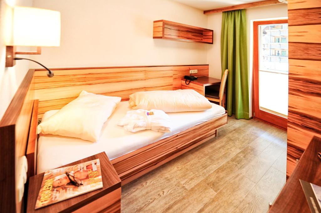 Postel nebo postele na pokoji v ubytování Hotel Arnika