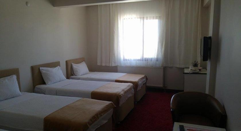 Postel nebo postele na pokoji v ubytování Butik Ertur Hotel