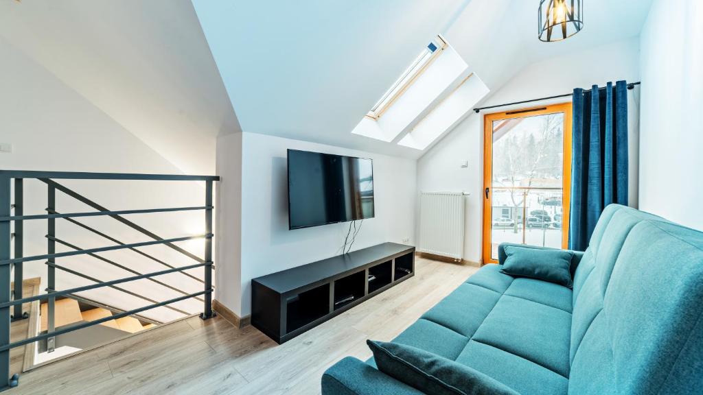 Televízia a/alebo spoločenská miestnosť v ubytovaní Apartamenty Sun & Snow Sarnia Residence