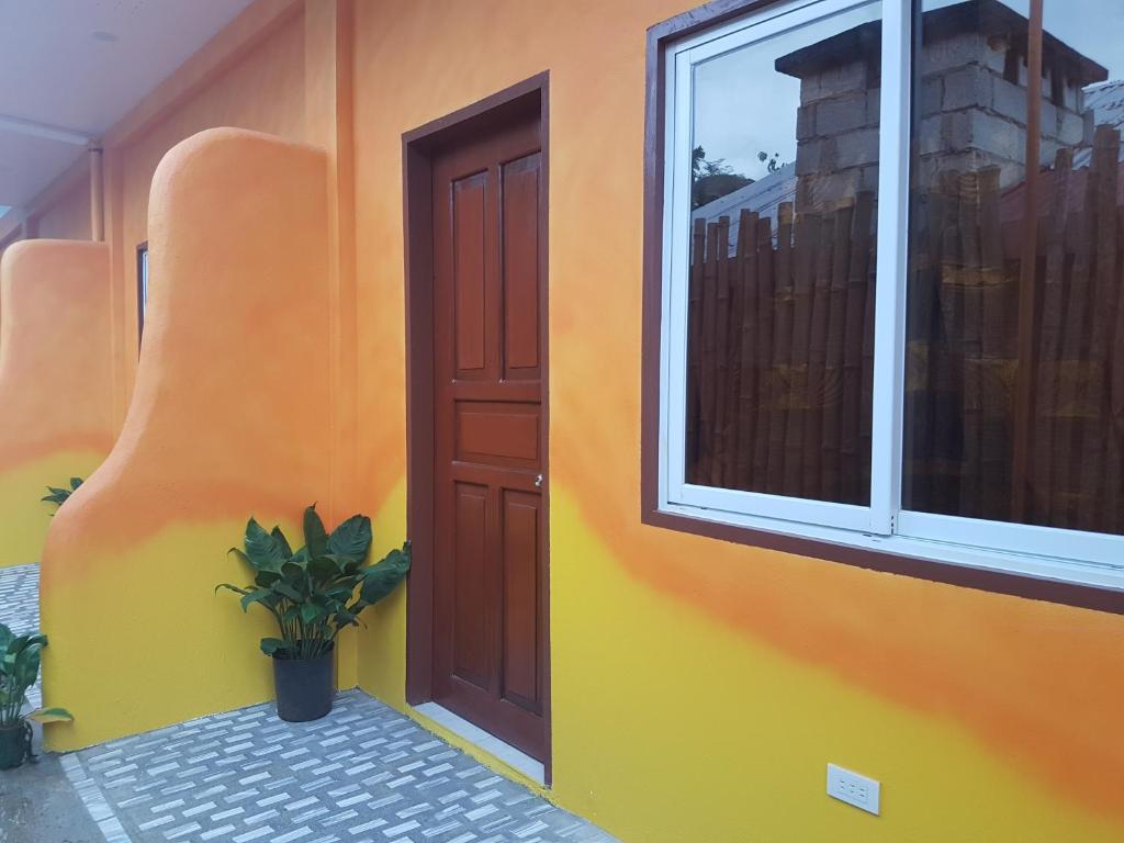 a house with a door and a plant in front of it at Stella'z guesthouse in Siquijor