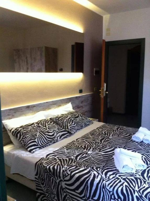 Postel nebo postele na pokoji v ubytování Hotel Alba