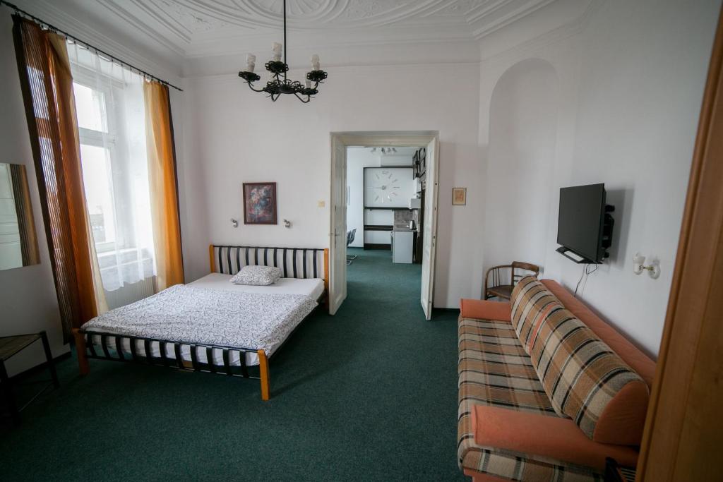 een woonkamer met een bed en een bank bij Apartment Kahoun in Praag