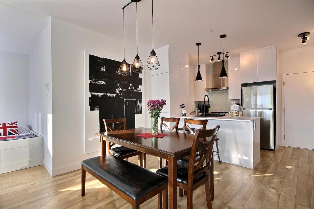 a kitchen and dining room with a table and chairs at Le Kaméléon 318 : interieur parking, rooftop terrace, gym in Quebec City