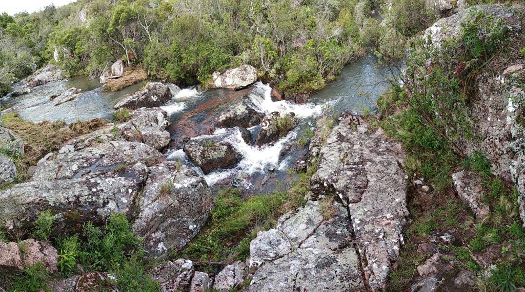 um riacho de água numa montanha com pedras em Tao Sierras De Aigua em Aiguá