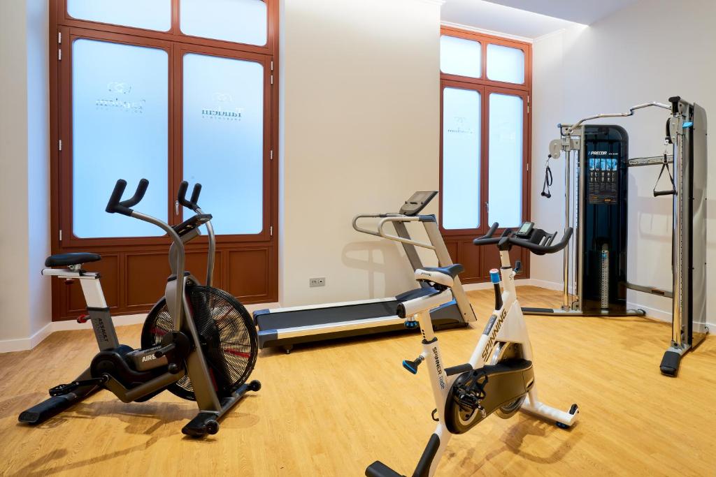 a gym with three exercise bikes in a room at Tandem Soho Suites in Málaga