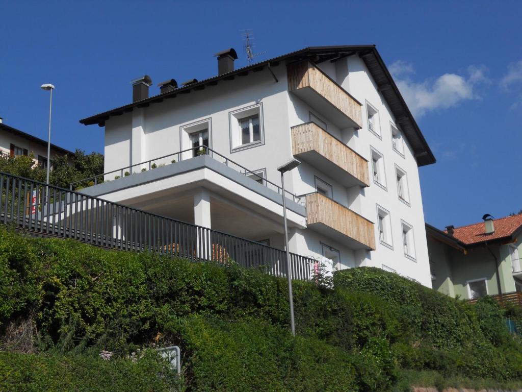 a white building on top of a hill at Casa Maria in Molveno