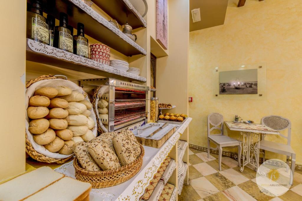 a kitchen with a counter with lots of bread at Hotel Argantonio in Cádiz