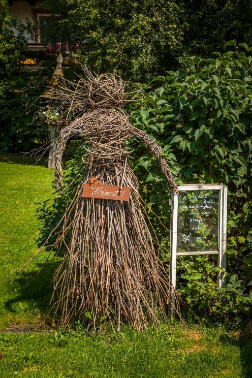 a statue of a person standing in the grass at Urbangut in Sankt Michael im Lungau