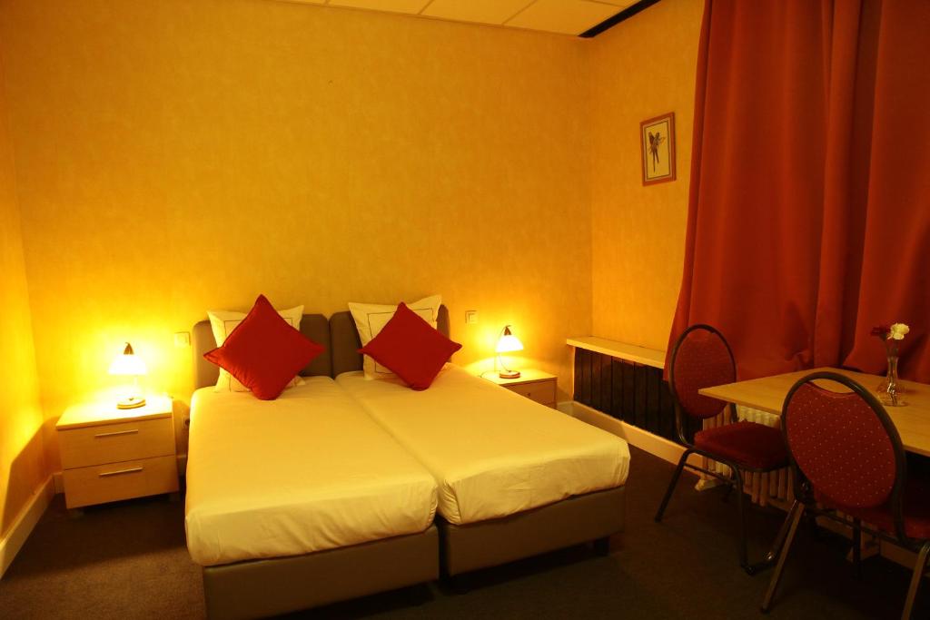 Postel nebo postele na pokoji v ubytování Hotel De Spiegel