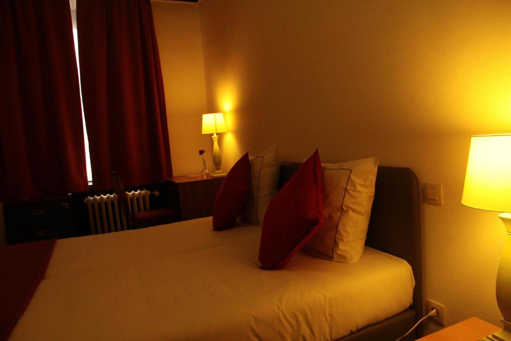 Postel nebo postele na pokoji v ubytování Hotel De Spiegel