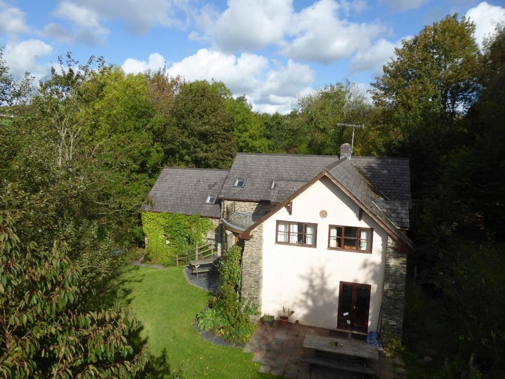 an aerial view of a white house in the woods at Ceridwen Holiday Home in Llandysul