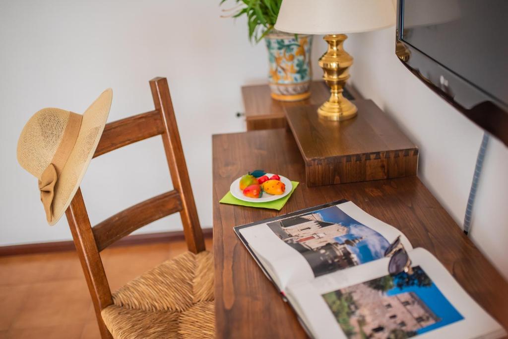a table with a plate of fruit and a plate of food at Hotel Villa Sirina in Taormina