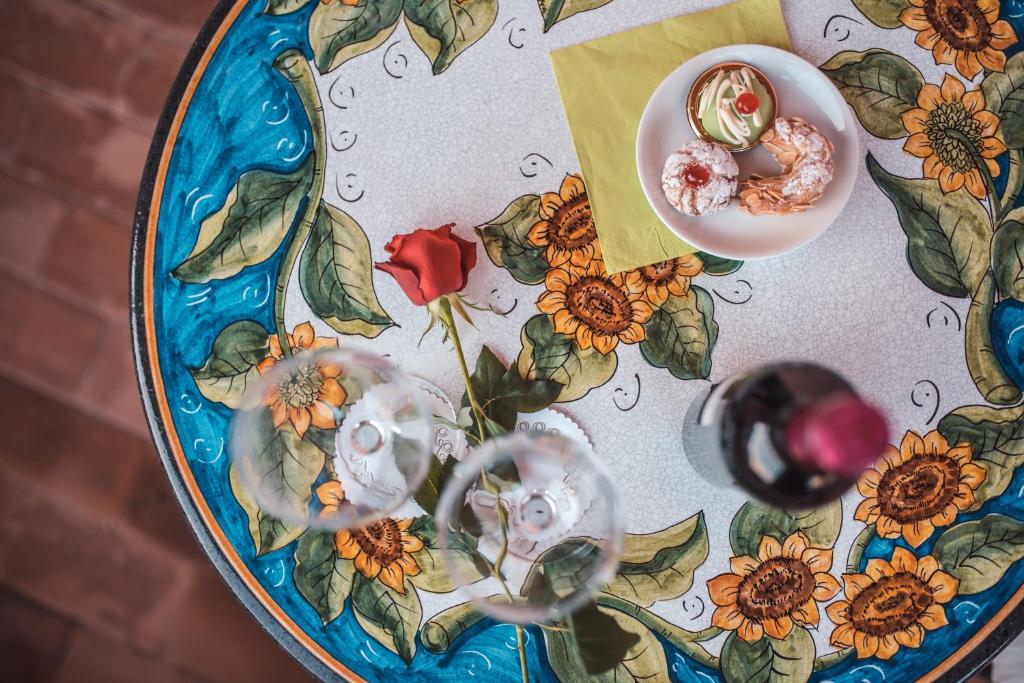a table with a plate of food on a table at Hotel Villa Sirina in Taormina