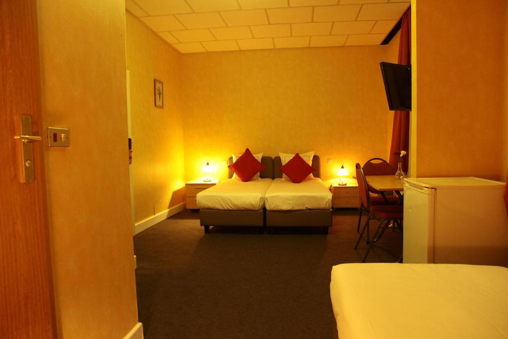 Postel nebo postele na pokoji v ubytování Hotel De Spiegel