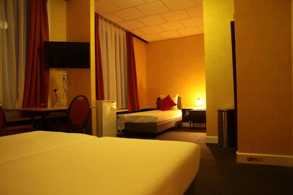 Postel nebo postele na pokoji v ubytování Hotel De Spiegel
