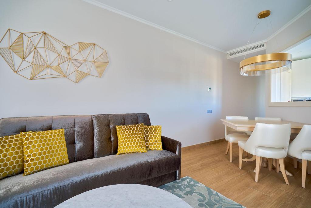 a living room with a couch and a table at Tandem Soho Suites in Málaga