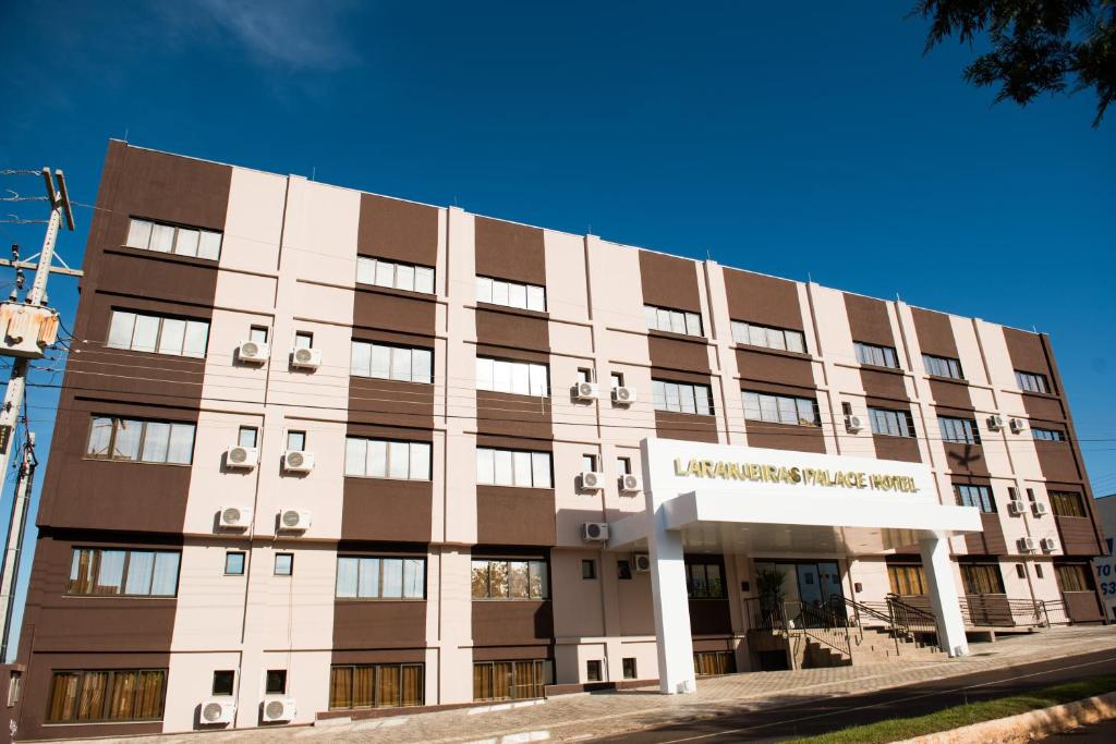 a large white building with brown at Laranjeiras Palace Hotel in Laranjeiras do Sul