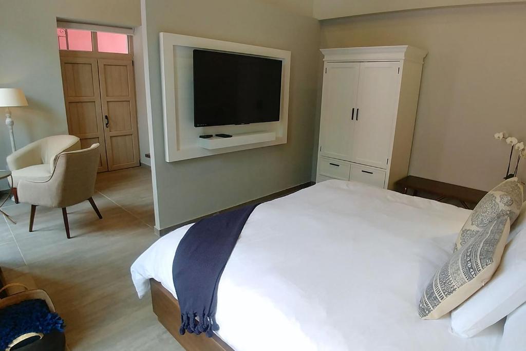 Postel nebo postele na pokoji v ubytování Hotel Casa Once