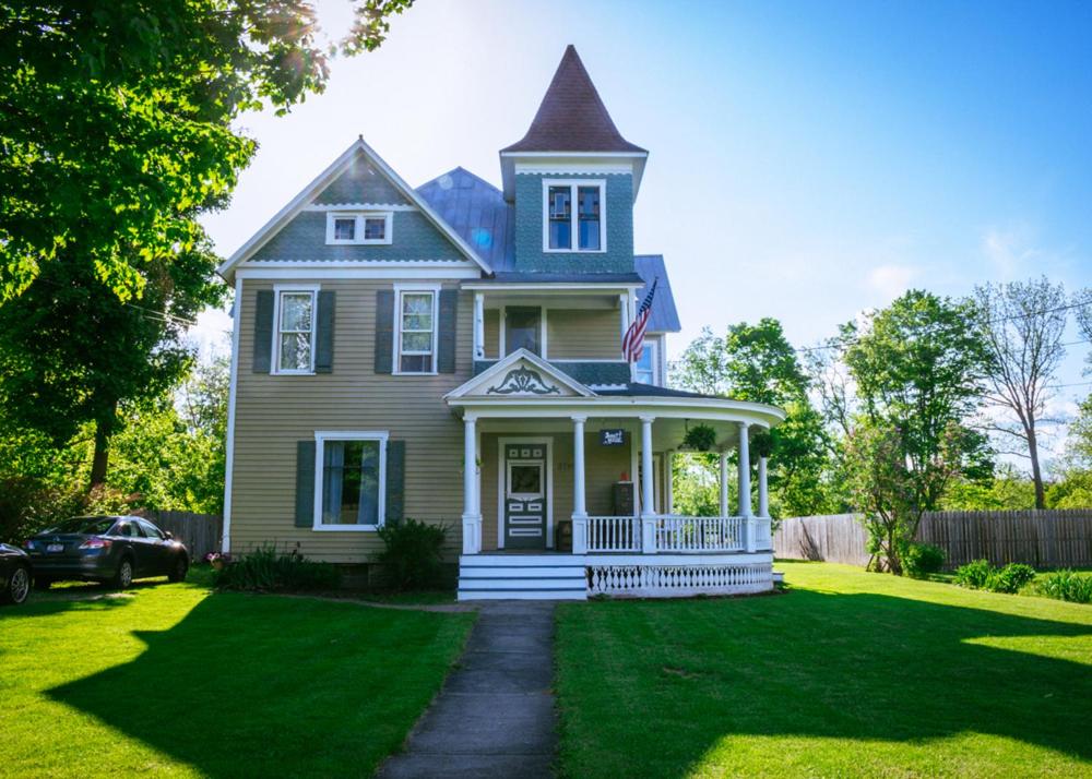 a large house with a porch and a lawn at Burdett House Bed & Breakfast in Burdett