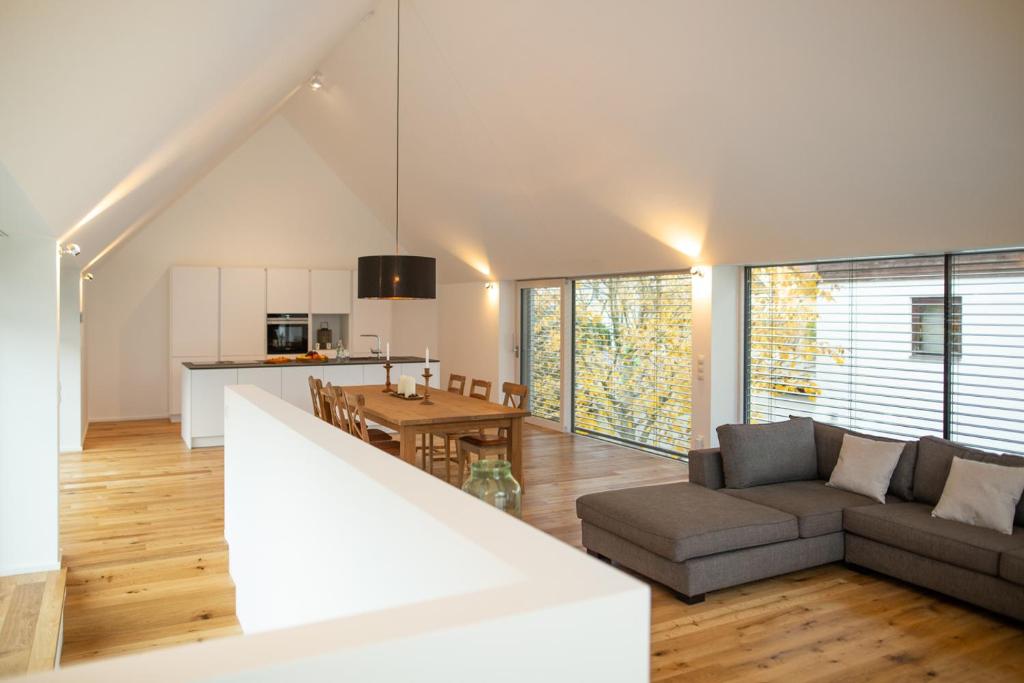 a large living room with a couch and a kitchen at Salzburg Loft in Salzburg