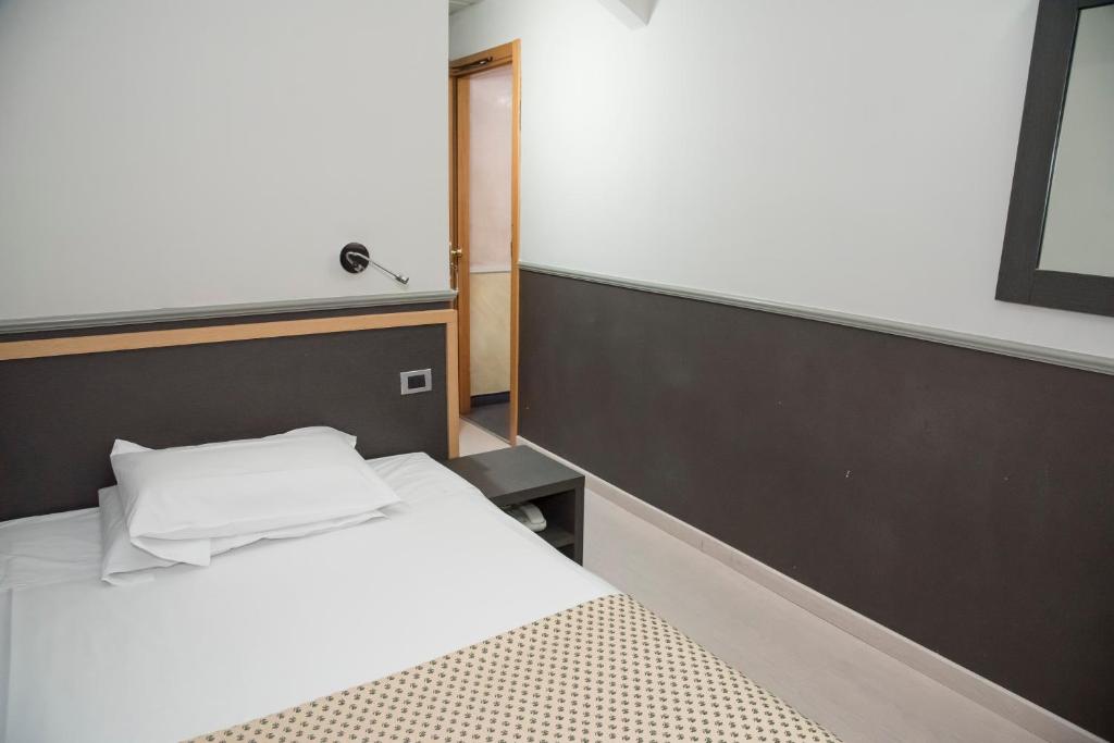 Postel nebo postele na pokoji v ubytování Hotel Corallo