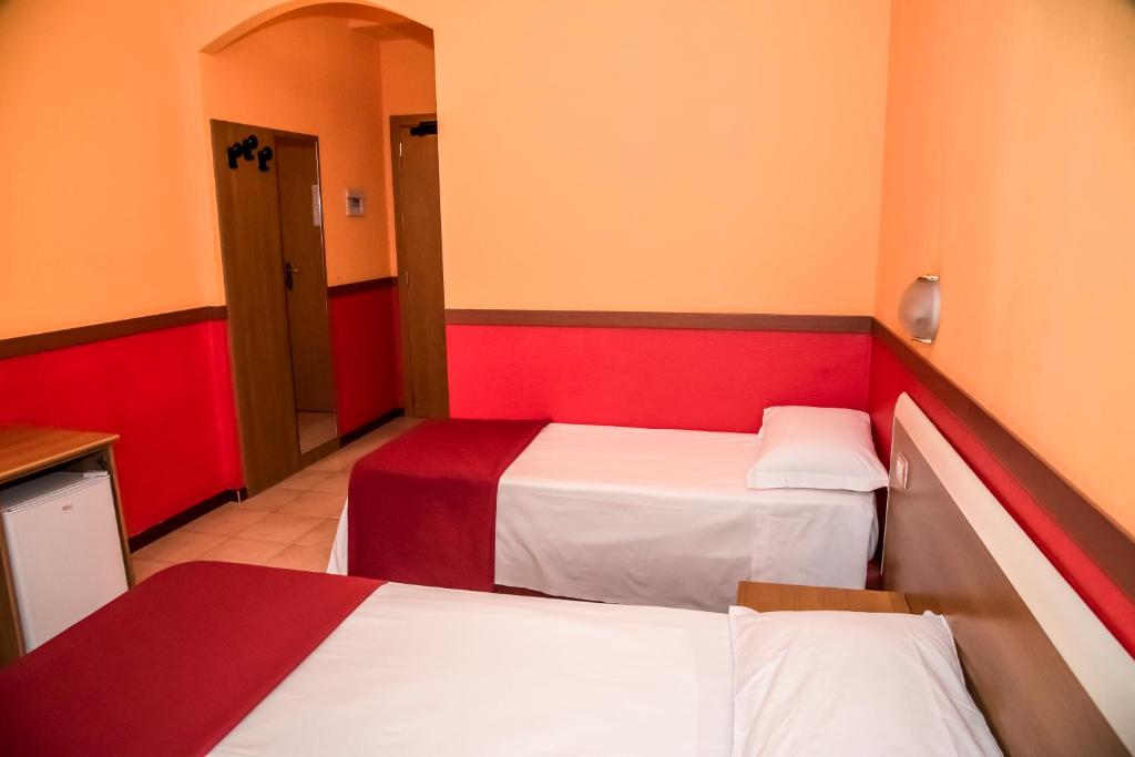 Postel nebo postele na pokoji v ubytování Hotel Corallo