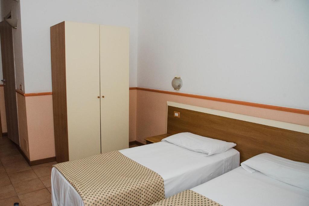 Postel nebo postele na pokoji v ubytování Hotel Corallo